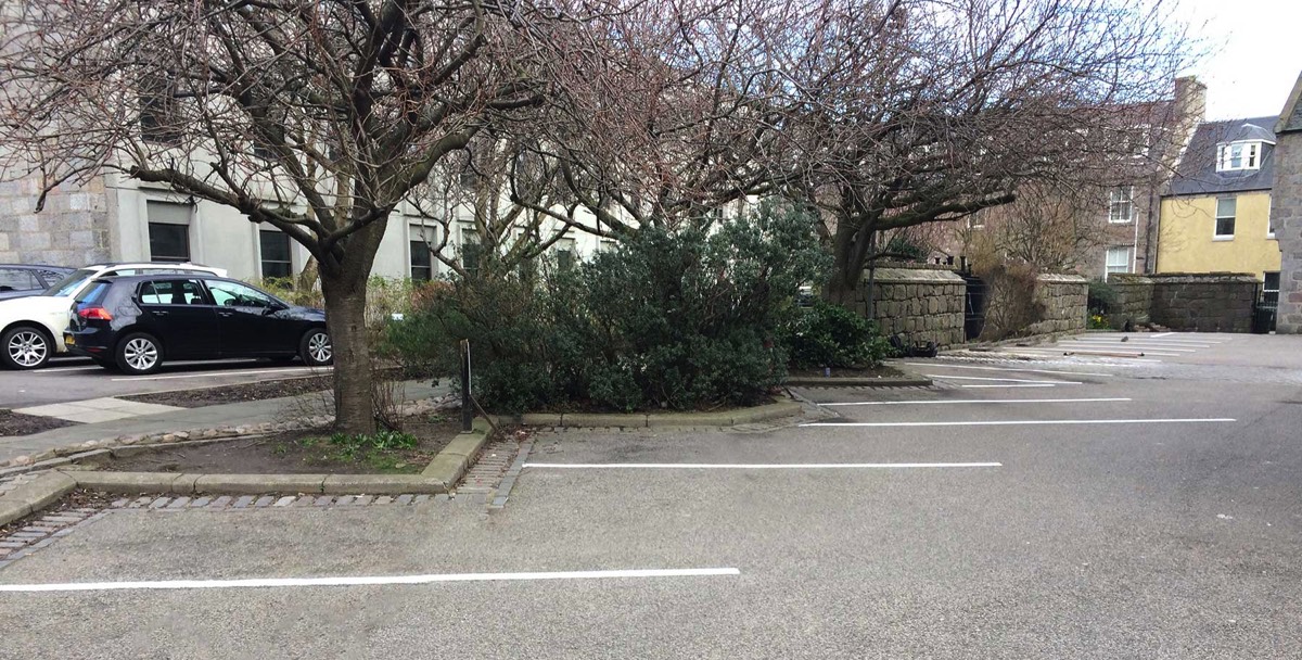 recently tarmacked car park with white line painting for parking spaces