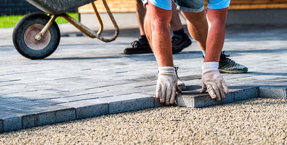 tradesman laying a paved block driveway at a property in Aberdeen City