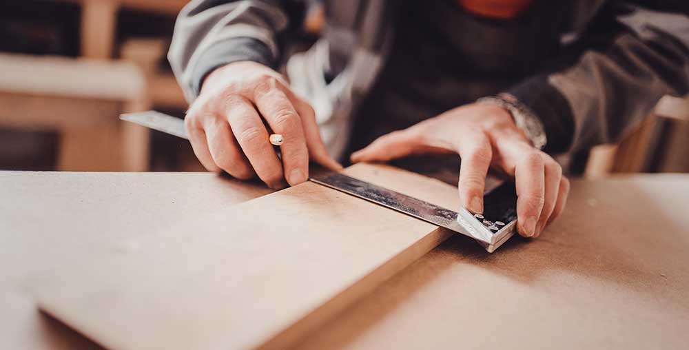 tradesman working with wood within a residential property in Scotland